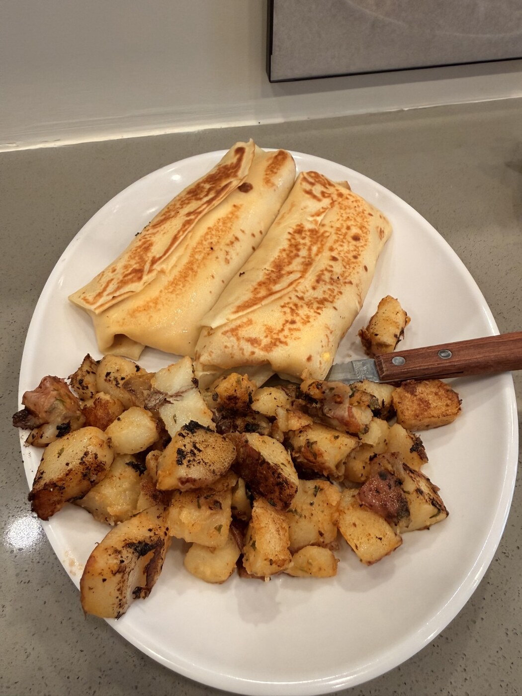 Freshly prepared crepes with home fries at The 80's Cafe